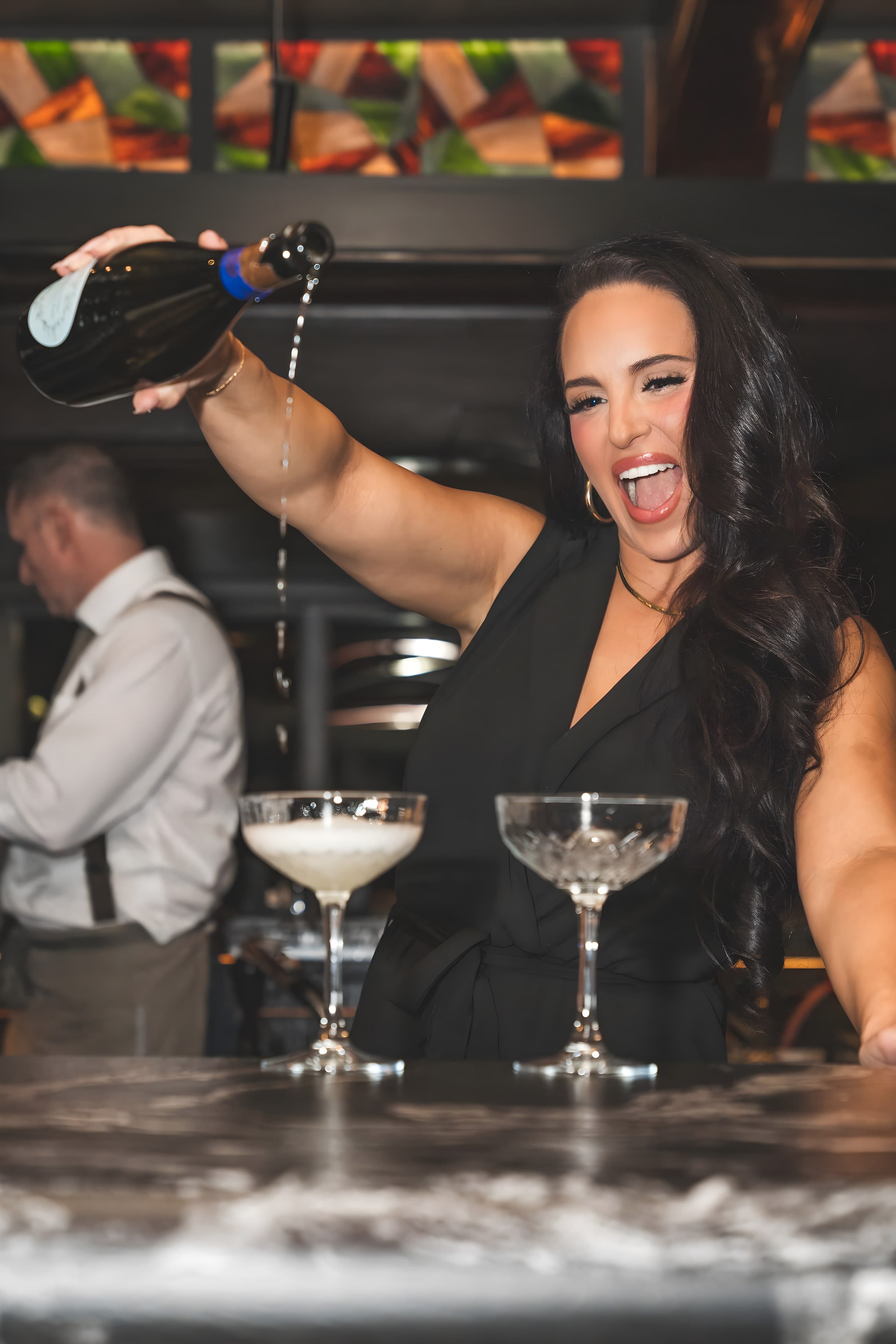 A celebratory pour at the Ember & Eagle bar