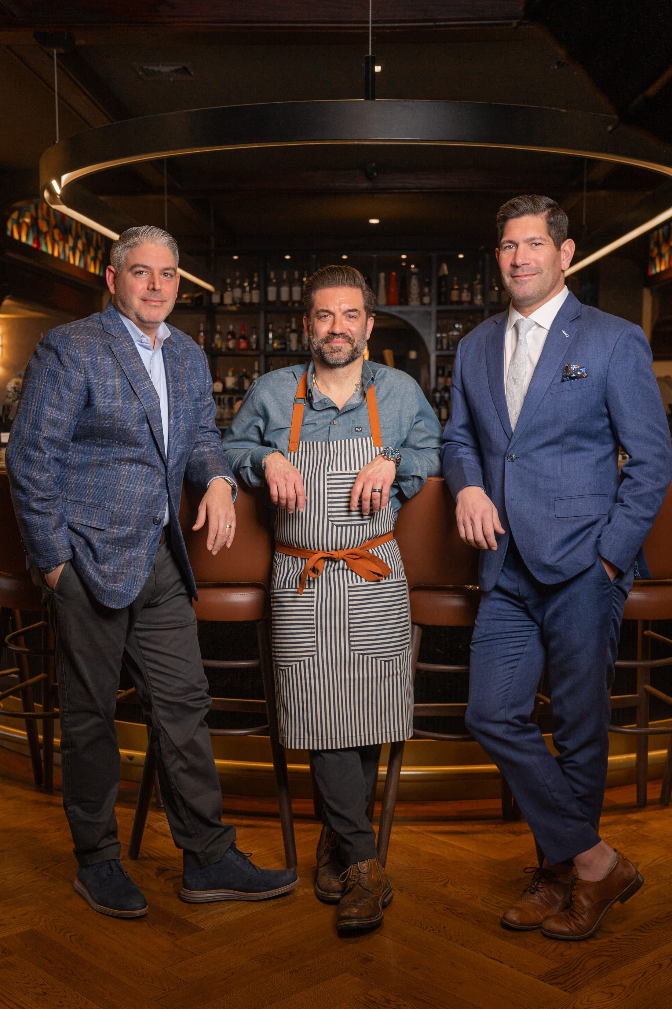 The three partners behind Ember & Eagle at the bar